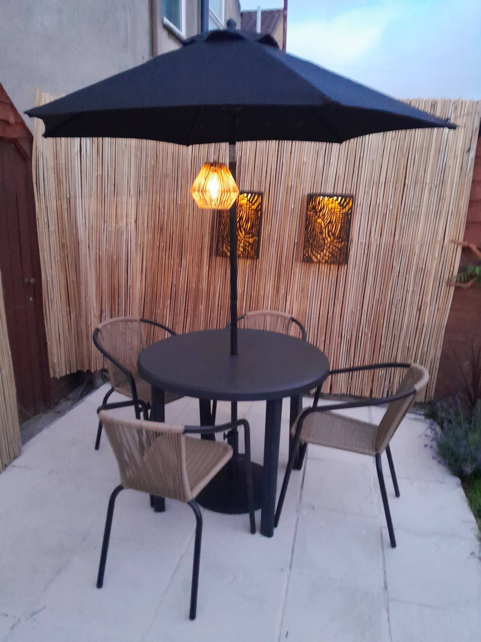 Outdoor patio seating area with umbrella and heater