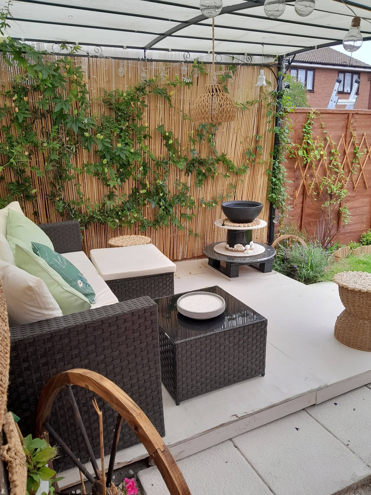 Modern outdoor patio seating area with pergola and fire bowl
