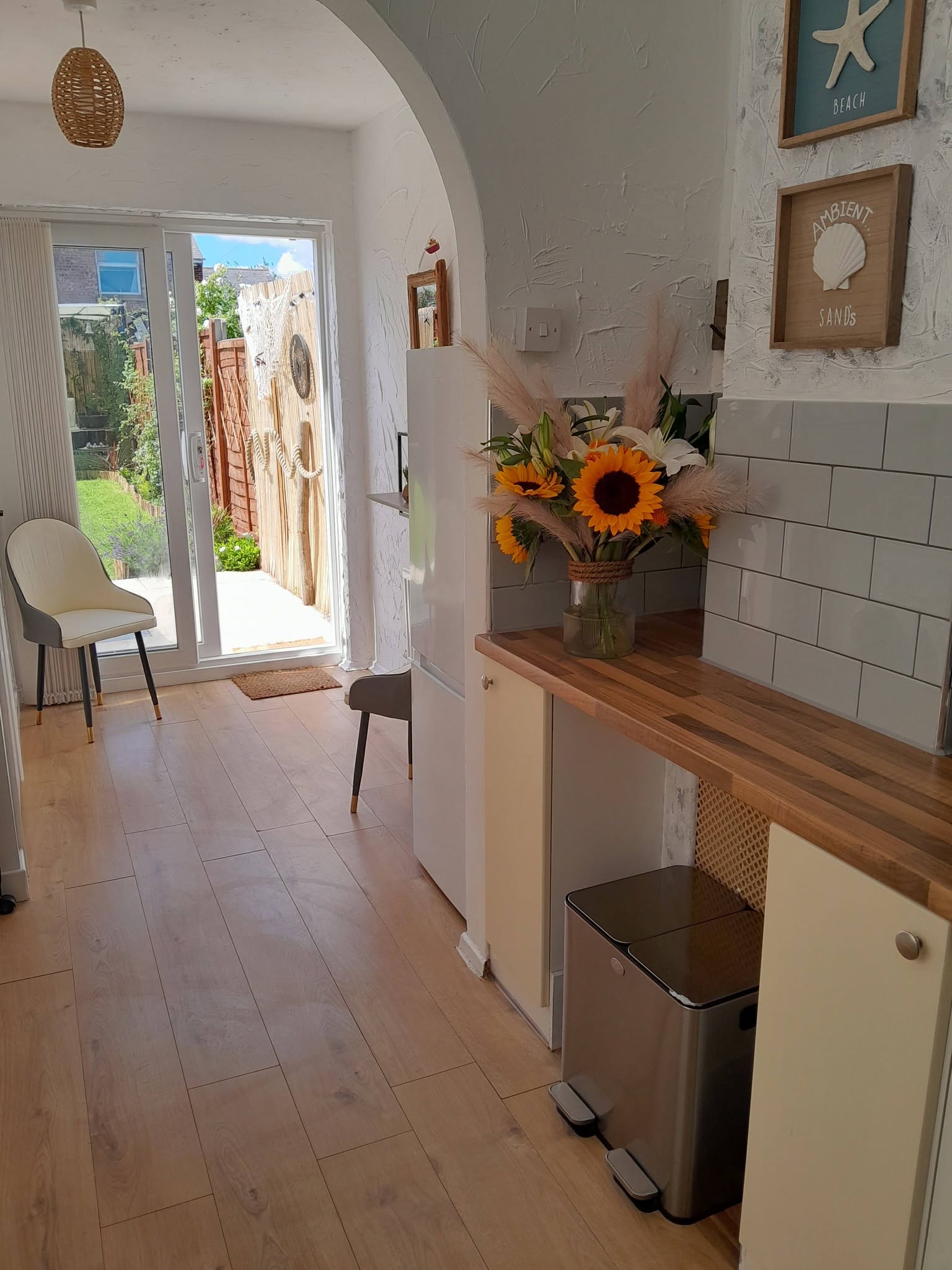 Bright coastal-themed kitchen with sunflowers and beach decor