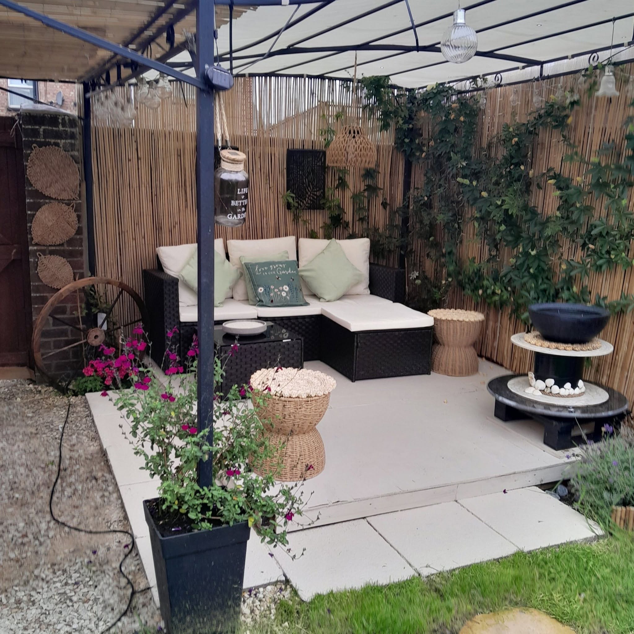 Outdoor pergola lounge area with seating and fire pit