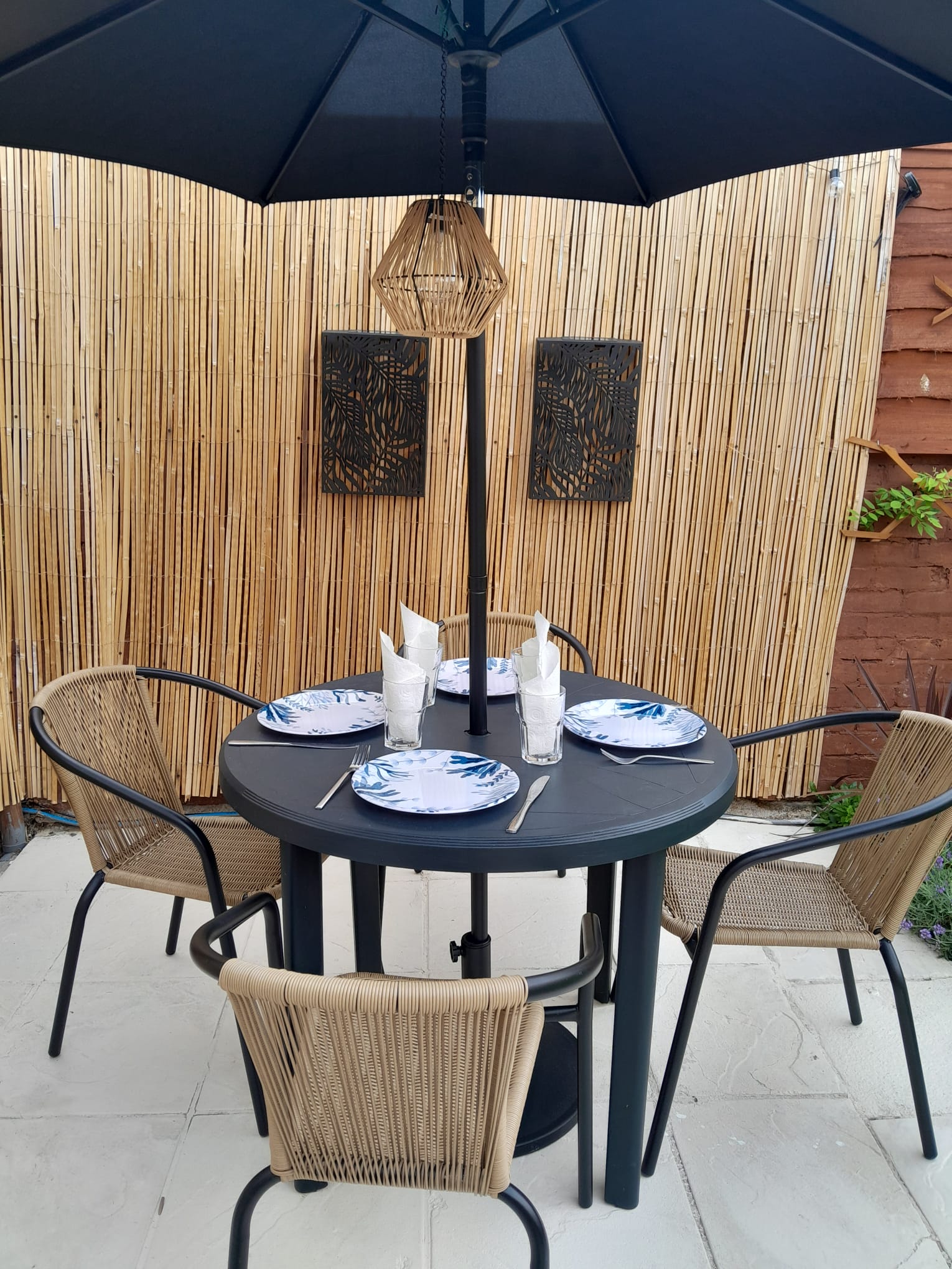 Alfresco dining table set for four in the garden