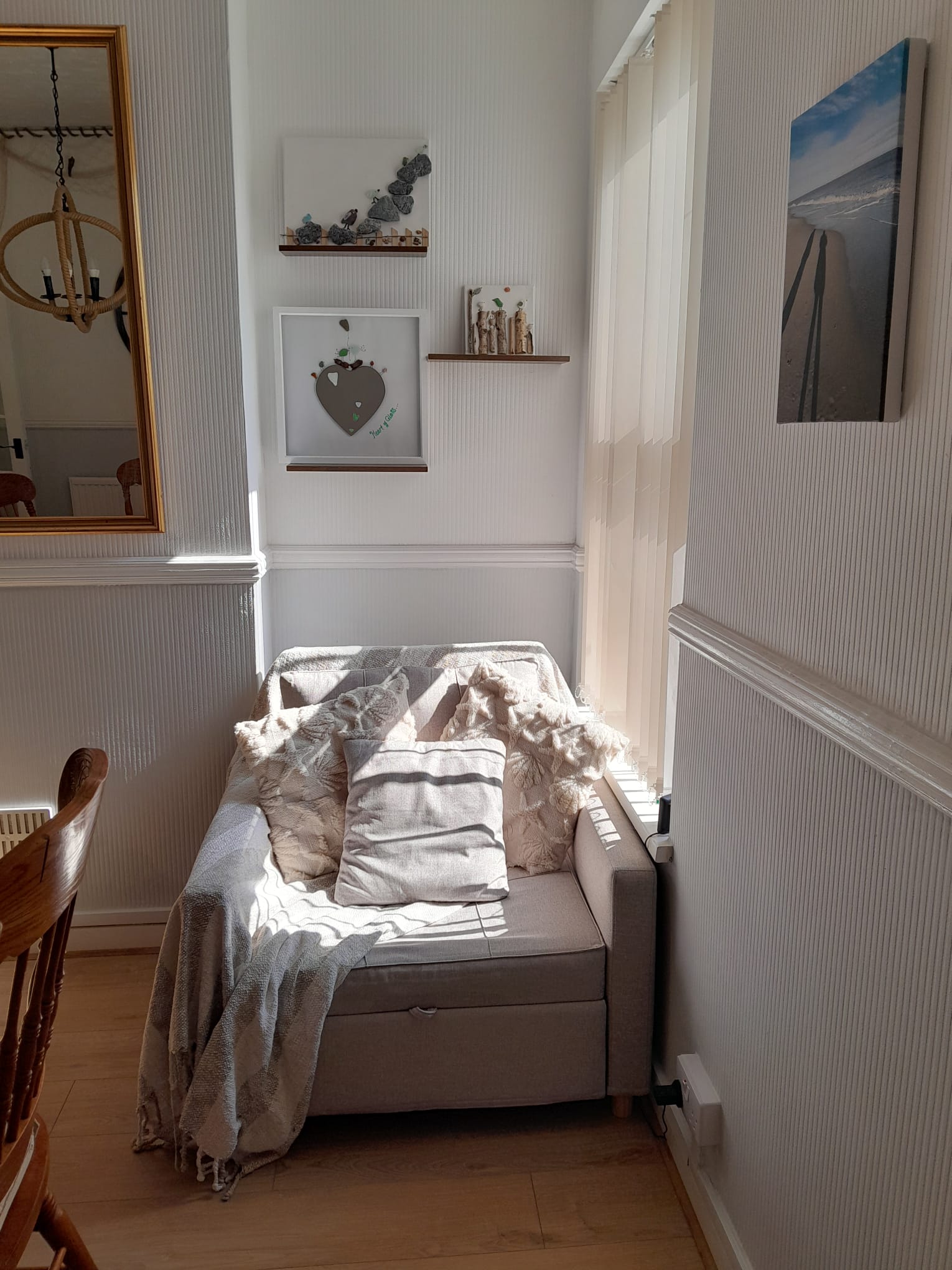 Ground floor sofa bed with cushions in a sunny nook at Ambient Sands